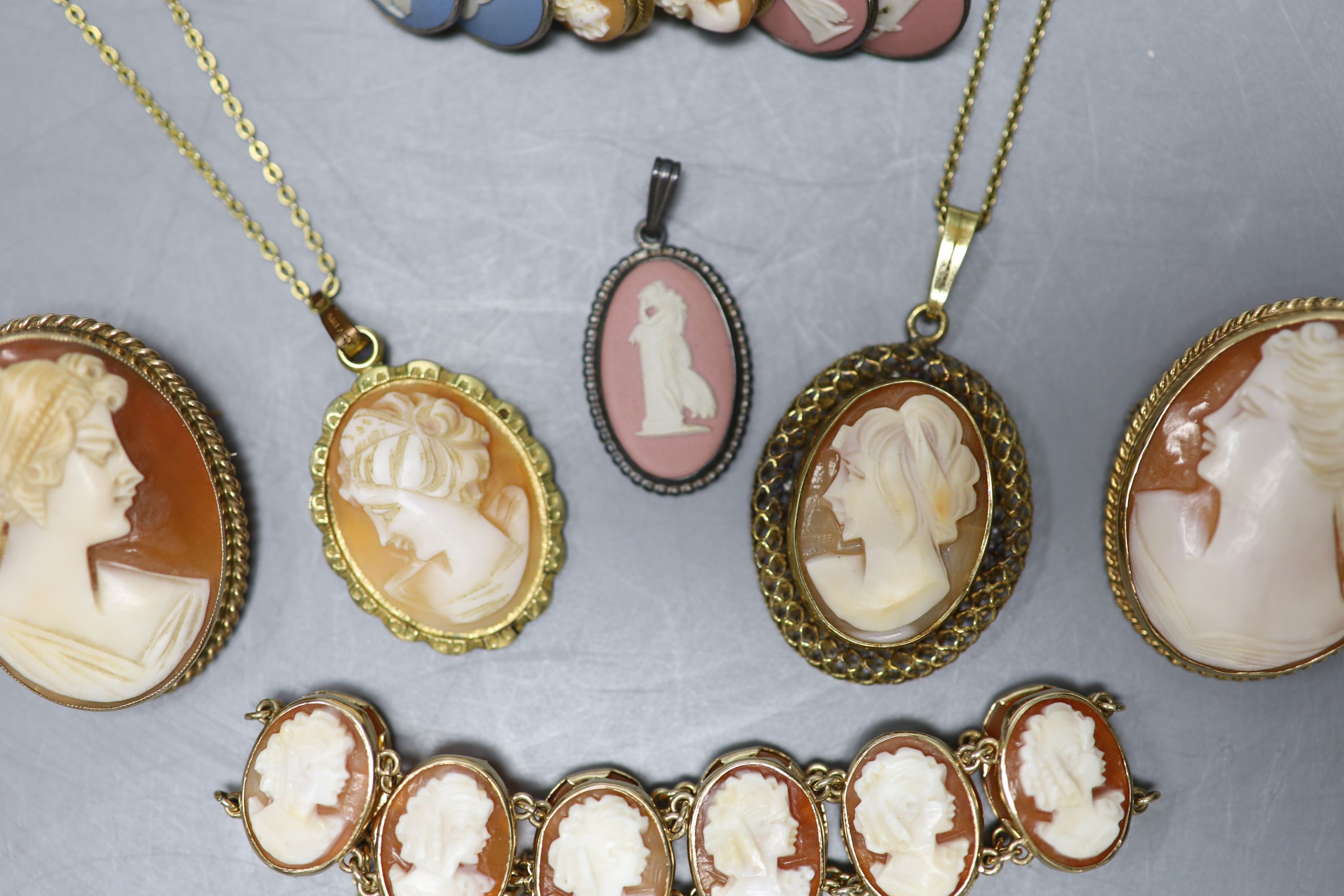 A modern 9ct gold and oval cameo shell bracelet, 16cm, two 9ct mounted cameo shell brooches, a pair of 9ct gold and cameo shell earrings and seven other items, 9ct gross 31.4 grams.